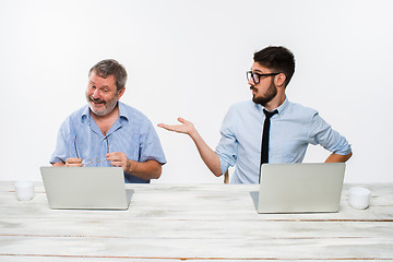 Image showing The two colleagues working together at office on white background