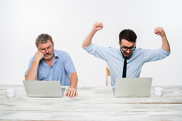 Image showing The two colleagues working together at office on white background