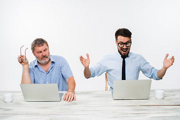 Image showing The two colleagues working together at office on white background