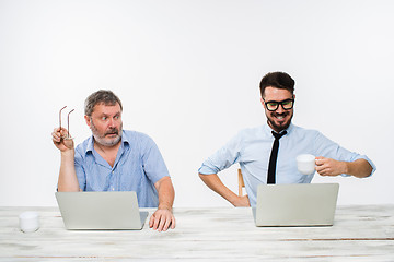 Image showing The two colleagues working together at office on white background