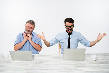 Image showing The two colleagues working together at office on white background