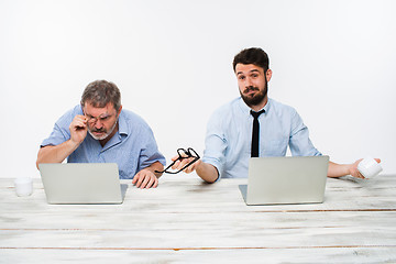 Image showing The two colleagues working together at office on white background