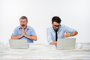 Image showing The two colleagues working together at office on white background