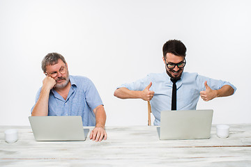 Image showing The two colleagues working together at office on white background