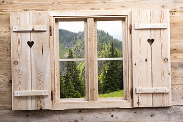 Image showing Wooden window with mountain reflections