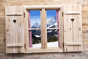 Image showing Wooden window with snowy mountain reflections