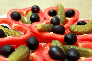 Image showing Black olives, marinaded cucumbers and paprika