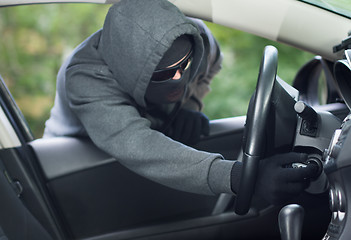 Image showing Burglar wearing mask balaclava, car burglary