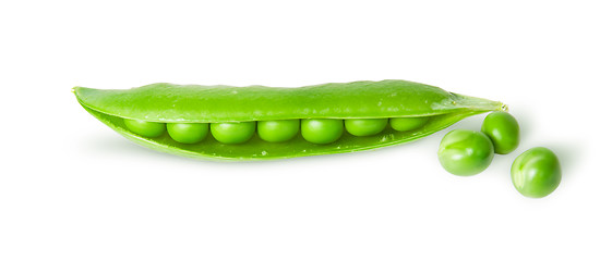 Image showing Opened green pea pod and peas top view