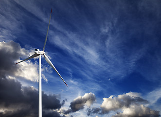 Image showing Wind turbine and blue sky with storm clouds
