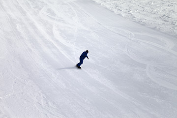 Image showing Ski slope and snowboarder at sun day