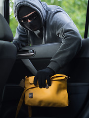 Image showing Transportation crime concept .Thief stealing bag from the car