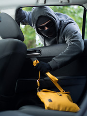 Image showing Transportation crime concept .Thief stealing bag from the car