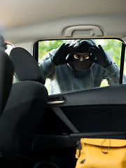 Image showing Transportation crime concept .Thief stealing bag from the car