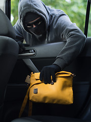 Image showing Transportation crime concept .Thief stealing bag from the car