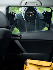 Image showing Transportation crime concept .Thief stealing bag from the car