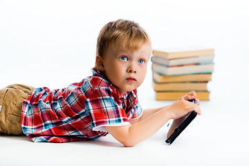 Image showing small boy with tablet computer and books