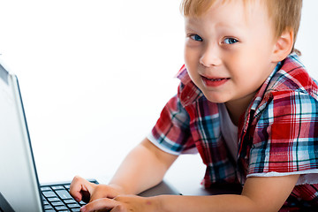 Image showing little blue-eyed boy with a laptop