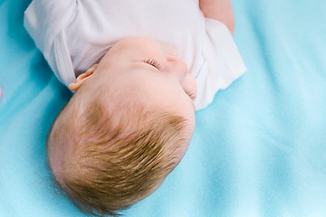 Image showing Baby on a blue blanket