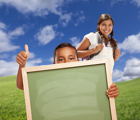 Image showing Students with Thumbs Up in Field Holding Blank Chalk Board
