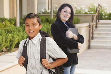 Image showing Hispanic Boy with Backpack on School Campus and Teacher Behind