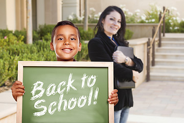 Image showing Boy Holding Back To School Chalk Board with Teacher Behind