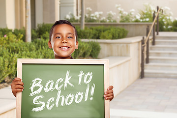 Image showing Boy Holding Back To School Chalk Board on School Campus