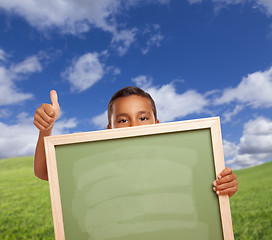 Image showing Boy with Thumbs Up in Field Holding Blank Chalk Board