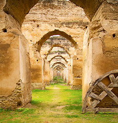 Image showing old moroccan granary in the green grass and archway  wall