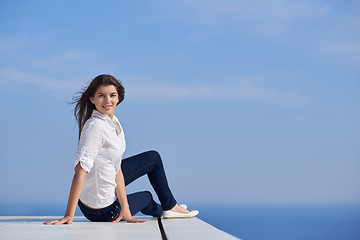 Image showing relaxed woman in front of luxury modern home