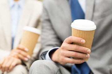 Image showing close up of business people hands with coffee cups