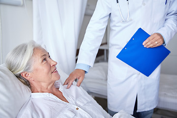 Image showing doctor visiting happy senior woman at hospital