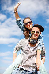 Image showing smiling teenagers in sunglasses having fun outside