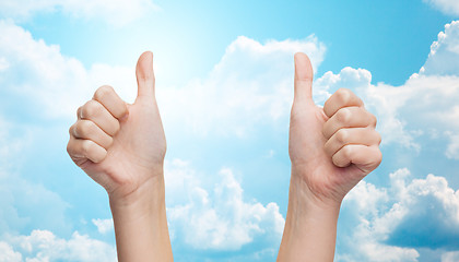 Image showing woman hands showing thumbs up over blue sky