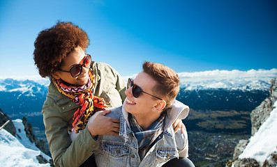 Image showing happy teenage couple in shades having fun outdoors