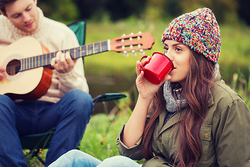 Image showing smiling couple with guitar in camping