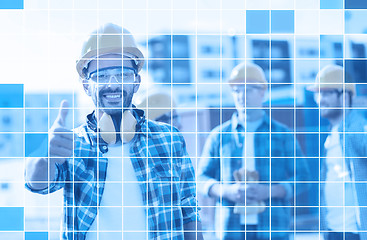 Image showing group of smiling builders in hardhats outdoors