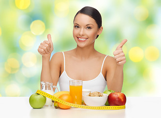 Image showing happy woman with healthy food showing thumbs up