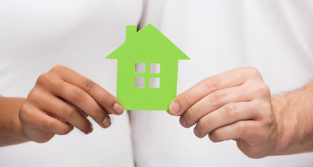 Image showing couple hands holding green house