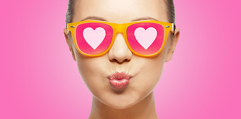 Image showing girl in pink sunglasses blowing kiss