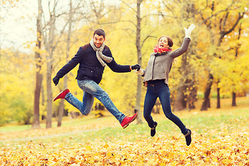 Image showing smiling couple having fun in autumn park