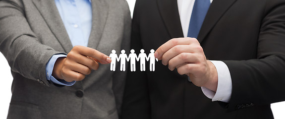 Image showing businessman and businesswoman holding paper team