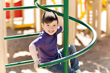 Image showing happy little boy climbing on children playground