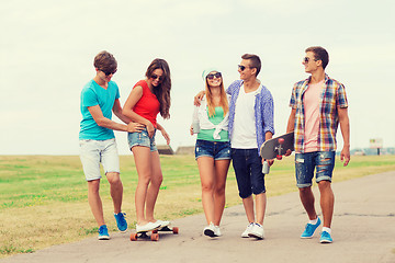 Image showing group of smiling teenagers with skateboards