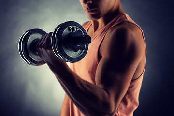 Image showing close up of young man with dumbbell