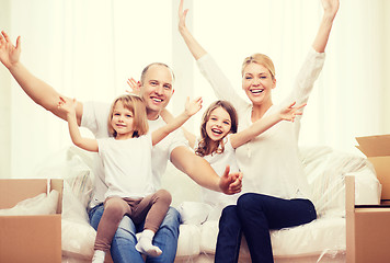 Image showing smiling parents and two little girls at new home