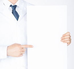 Image showing doctor holding blank white banner