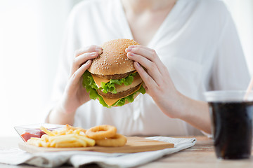 Image showing close up of woman hands holding hamburger