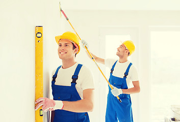 Image showing group of builders with tools indoors