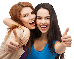 Image showing two smiling girls showing thumbs up